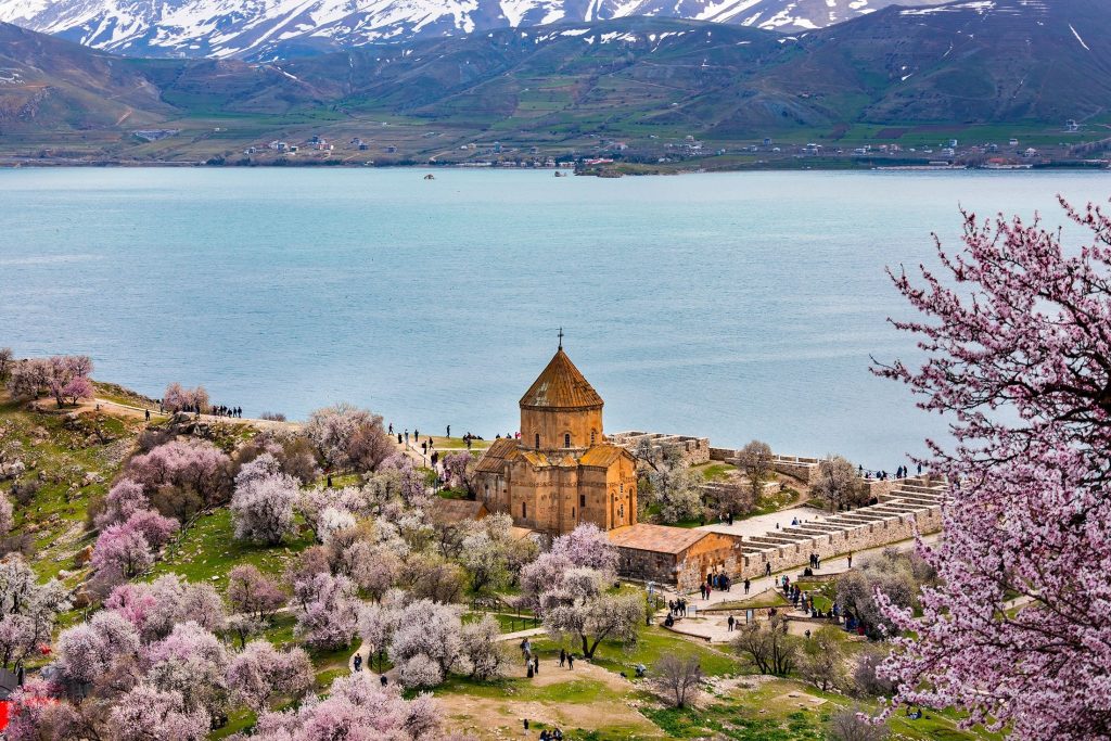 A large body of water with a mountain in the background