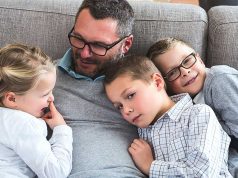 Delayed Fatherhood And Autism A young boy sitting on a couch