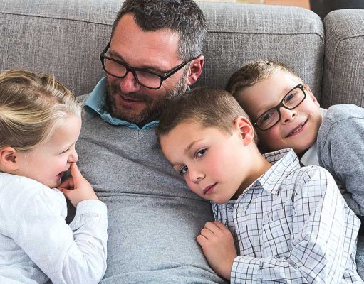 Delayed Fatherhood And Autism A young boy sitting on a couch