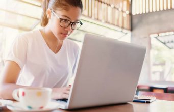 Building A Better Blogosphere A woman sitting at a table using a laptop