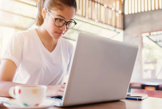 Building A Better Blogosphere A woman sitting at a table using a laptop