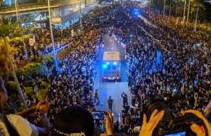 How To Start A Revolution A group of people in front of a crowd