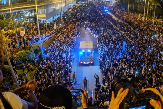 How To Start A Revolution A group of people in front of a crowd