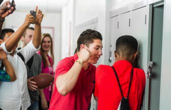 How To Protect Yourself From Bullies A group of people standing in a room