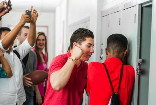 How To Protect Yourself From Bullies A group of people standing in a room