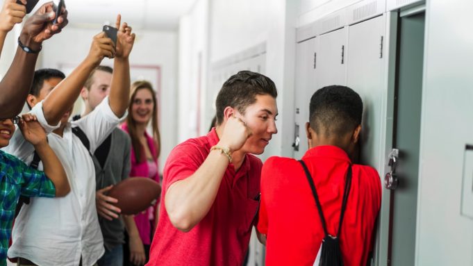How To Protect Yourself From Bullies A group of people standing in a room