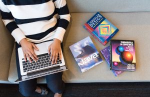 The Specialization Of Reaction A person sitting at a table using a laptop computer