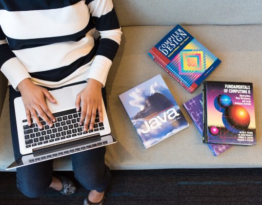 The Specialization Of Reaction A person sitting at a table using a laptop computer