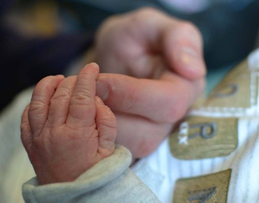 A Boy Is Born A hand holding a baby
