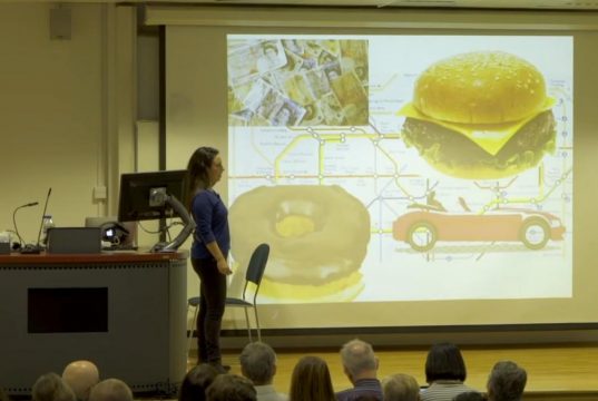 An Introduction To Evolutionary Psychology A group of people standing in front of a television