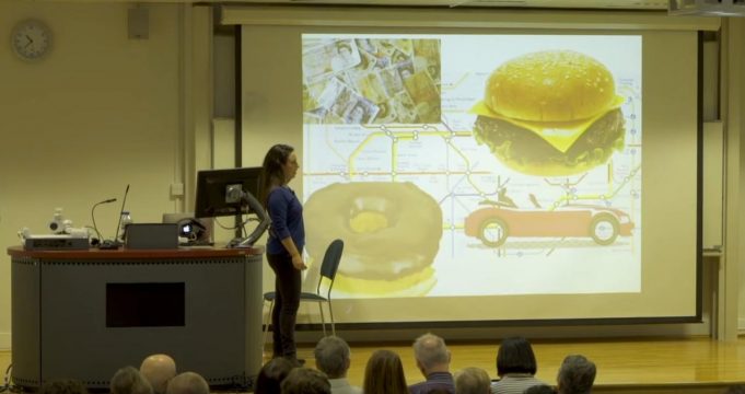 An Introduction To Evolutionary Psychology A group of people standing in front of a television