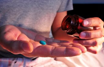 Seven Ways The Red Pill Will Improve Your Life A close up of a hand