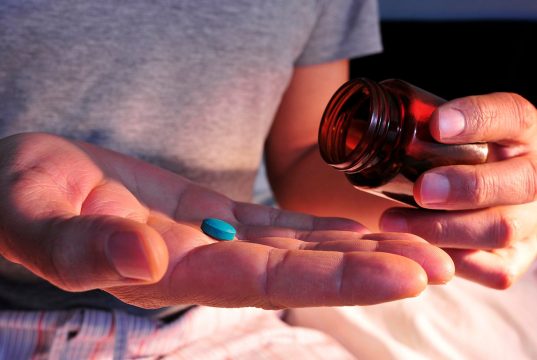 Seven Ways The Red Pill Will Improve Your Life A close up of a hand