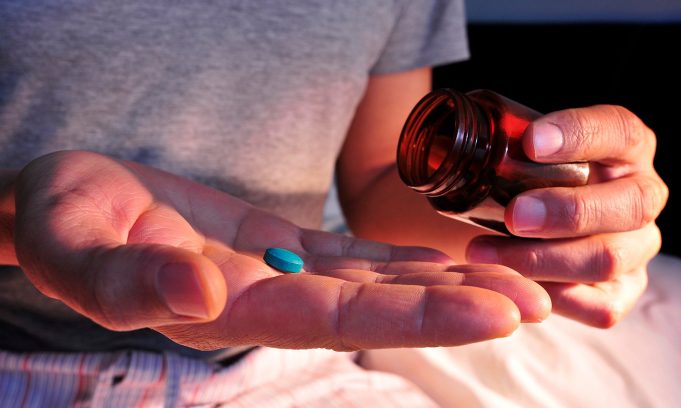 Seven Ways The Red Pill Will Improve Your Life A close up of a hand