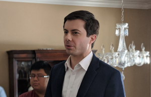 Victimocracy Peter Buttigieg wearing a suit and tie