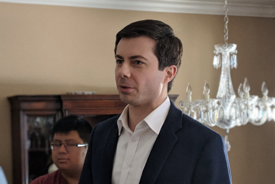 Victimocracy Peter Buttigieg wearing a suit and tie