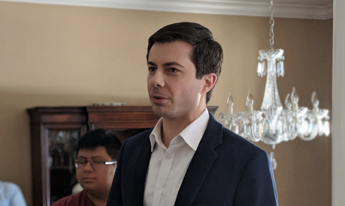Victimocracy Peter Buttigieg wearing a suit and tie