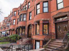 Real Estate Sales In Boston A bench in front of a brick building