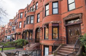 Real Estate Sales In Boston A bench in front of a brick building