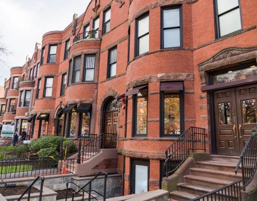 Real Estate Sales In Boston A bench in front of a brick building