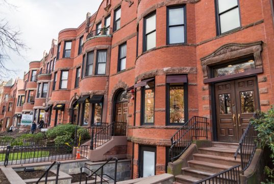 Real Estate Sales In Boston A bench in front of a brick building