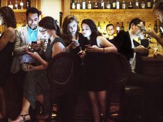 Evil Men Get Laid More Than You A group of people sitting in a restaurant