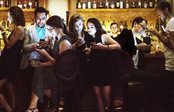 Evil Men Get Laid More Than You A group of people sitting in a restaurant